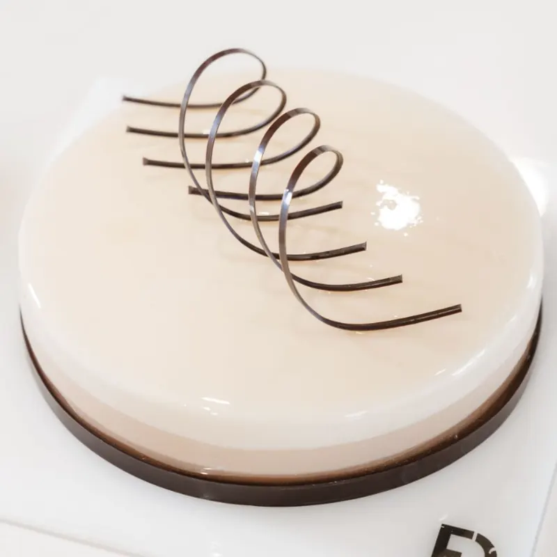 Torta con glassa beige e spirale di cioccolato